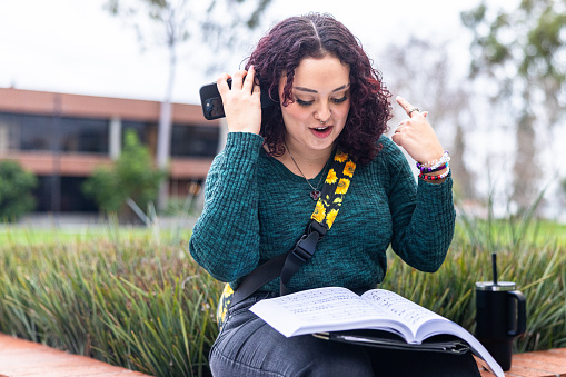 A young latino female college student on campus.