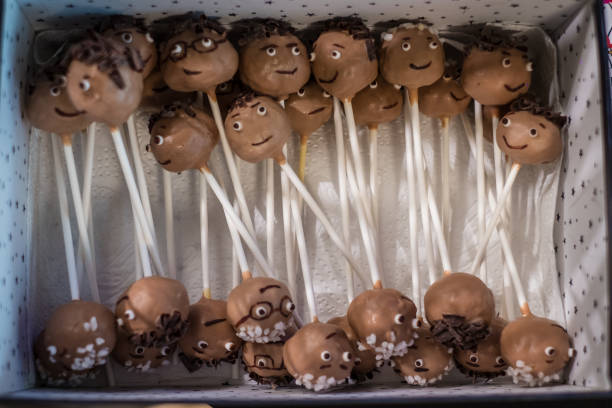 Close up color image depicting a box of gourmet chocolate truffles of different shapes and different varieties of chocolate. Selective focus with room for copy space.