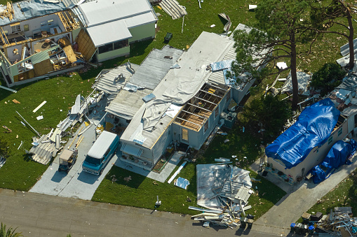 Badly damaged mobile homes after hurricane Ian in Florida residential area. Consequences of natural disaster.