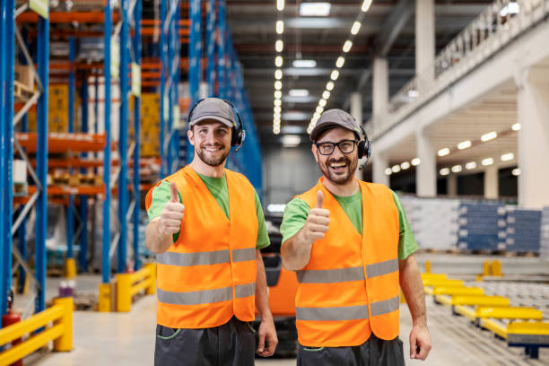 istock Two warehousemen giving thumbs up for delivery and shipment. 1963275327