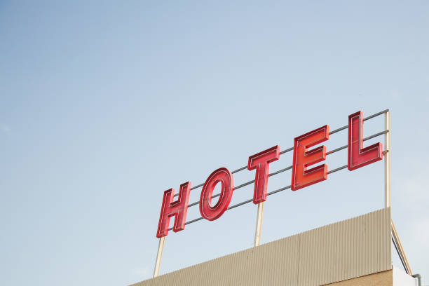 istock red inscription hotel on a roadside hotel building against a blue clear sky 1963295778