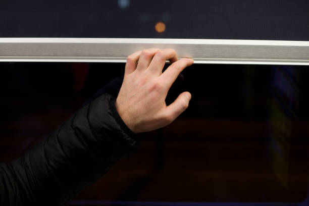 istock Man's hand closing the window curtain 1963310394