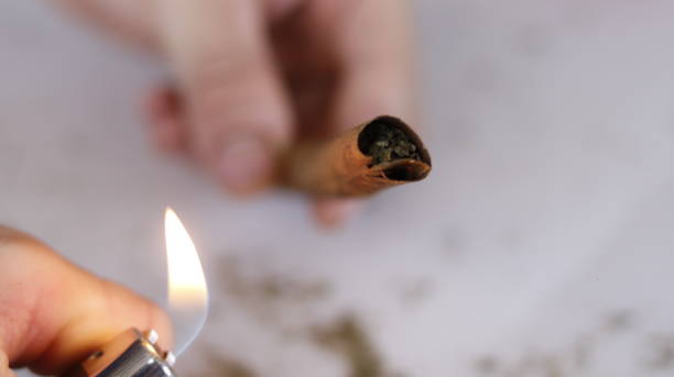 istock a person lighting a weed blunt 1963329728