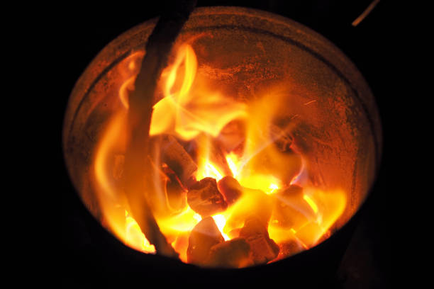 Bright orange flames emerging from a hot outdoor BBQ Charcoal Chimney Starter