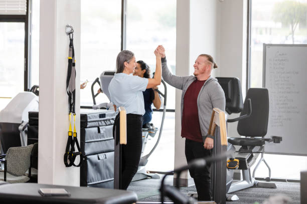 istock Female OT celebrates man's successful therapy session 1963396148