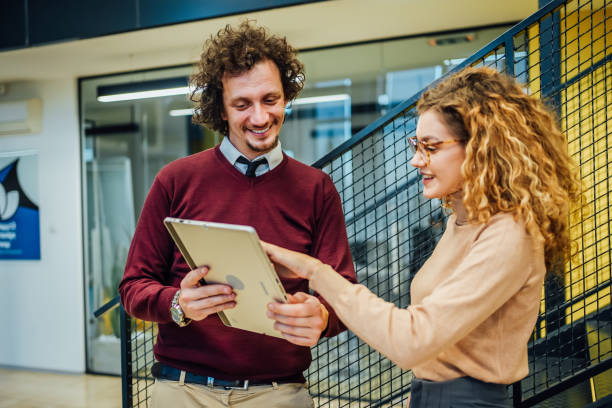 istock Young business man and woman using tablet 1963409504