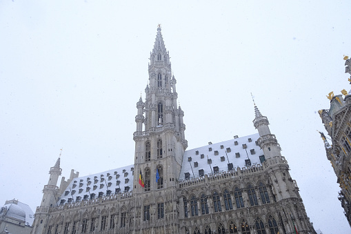 People walk in the snow covered Grand Place after heavy snowfall hit Brussels in Belgium on January 17, 2024.