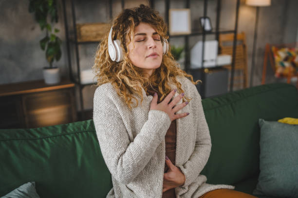 istock one woman doing guided meditation yoga self care practice at home 1963448607