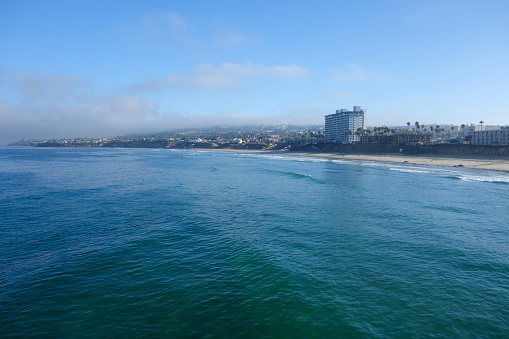 Early morning at Pacific Beach surrounded by seaside hotels and recreational areas as seen from Crystal Pier in San Diego, Southern California