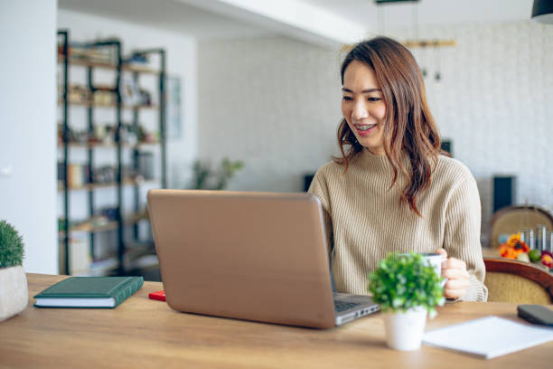 istock Young female entrepreneur working on a laptop 1963467598
