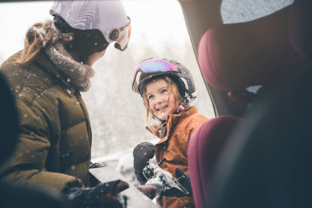 Mother and daughter getting unpacking the car for skiing