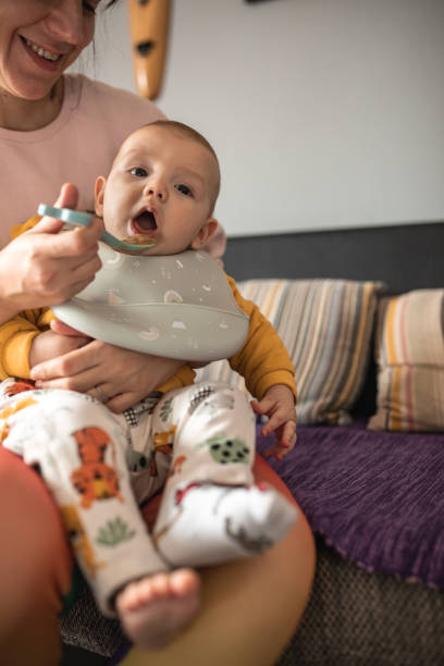 istock Cute baby boy is eating his first solid food. 1963558101