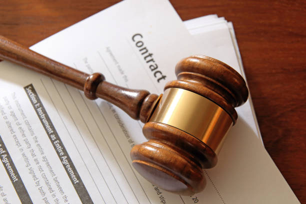 A gavel rests on top of a stack of legal documents that provide ample room for copy and text.
