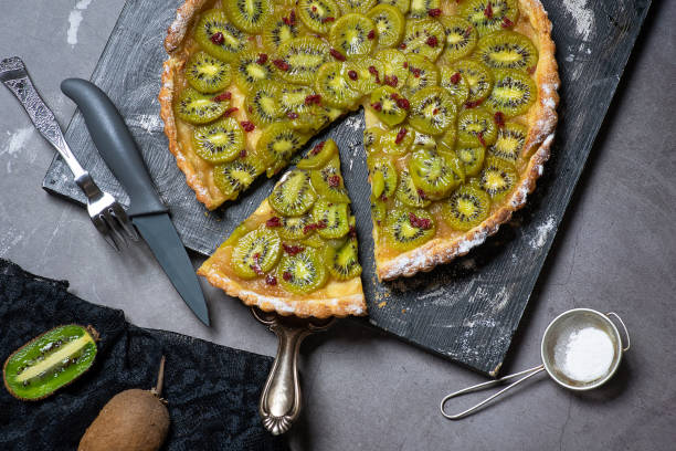 Studio shot of an individual fresh fruit flan cut out against a white background