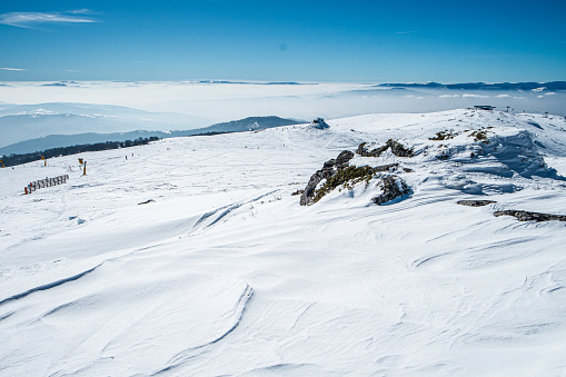 Beautiful winter landscape under the clear sky, white snow covering the mountain range