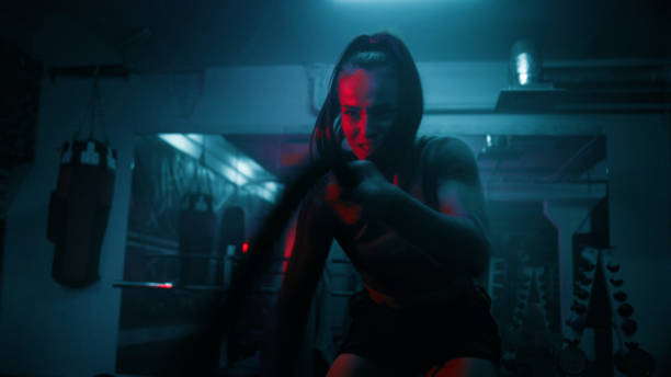 istock Female boxer does cardio or endurance exercises with ropes 1963650897