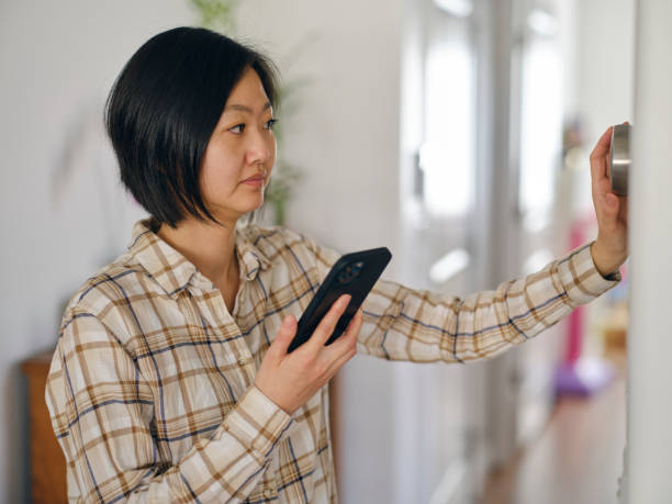 istock Woman Adjusting a Smart Thermostat in a Home 1963665274