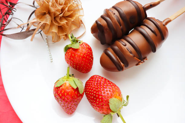 Melted chocolate with strawberries in a swirling shape isolated on a white background