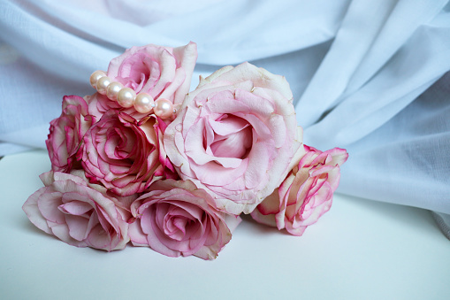 bouquet of pink roses and pearl beads