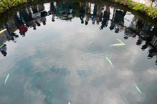 Yamanashi, Japan - August11 2018 - Oshino Hakkai（Japanese spring pond） water surface with silhouettes of tourists