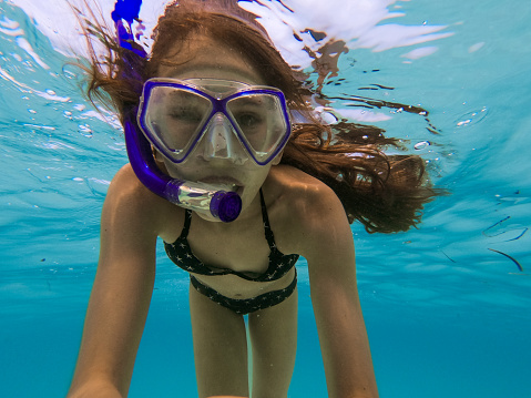 Happy Teen girl enjoying snorkeling