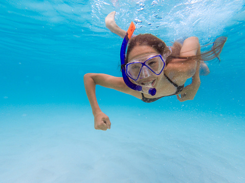 Happy Teen girl enjoying snorkeling