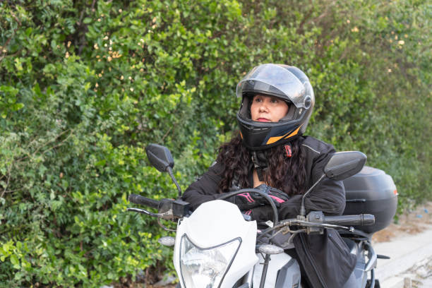 istock Focused Motorcyclist with Helmet Outdoors 1963783714