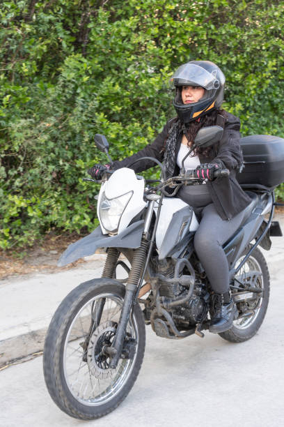 istock Woman Riding Motorcycle on Suburban Road 1963785259