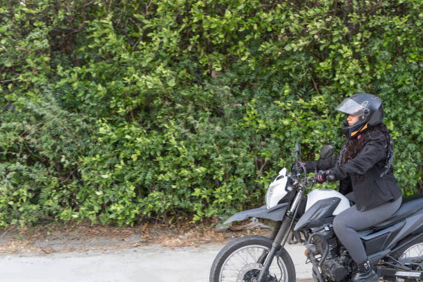 istock Female Motorcyclist Starting Her Journey 1963785274