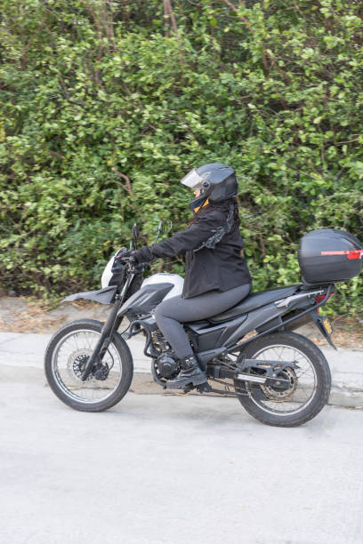 istock Confident Female Biker Riding Through Nature 1963786303