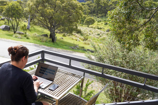 istock A woman working remotely from her balcony looking over bushland and mountains 1963790455