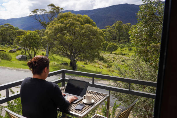 istock A woman working remotely from her balcony looking over bushland and mountains 1963797233