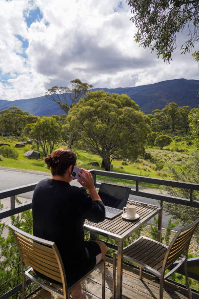 istock A woman working remotely from her balcony looking over bushland and mountains 1963797759
