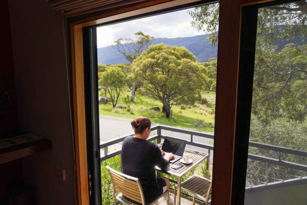 istock A woman working remotely from her balcony looking over bushland and mountains 1963798279