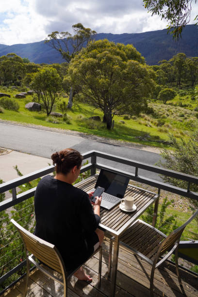 istock A woman working remotely from her balcony looking over bushland and mountains 1963798565