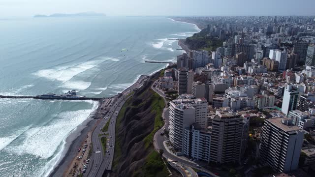 Miraflores, Peru , we can see the pacific ocean in Costa verde as well as some people practicing paragliding.