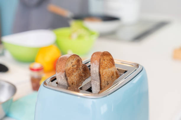 housewife frying bread in a toaster, in the kitchen. woman making toast. bread for toast. toast bread in a toaster. crispy bread. classic toaster. High quality photo