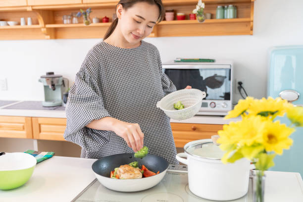 istock asian woman cooks in a kitchen, 1963888800