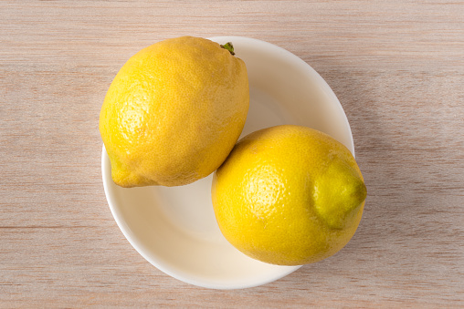 Two Lemons in a Bowl