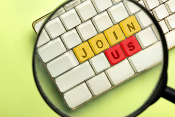 istock The magnifying glass focuses on the computer keyboard button with Join Us words 1963964140