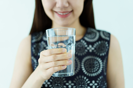 matcha Collagen powder in in spoon and glass of water, Healthy and anti-age concept. creative