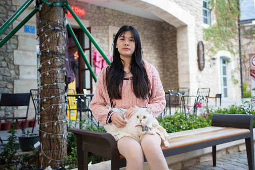 Asian woman sitting on a bench