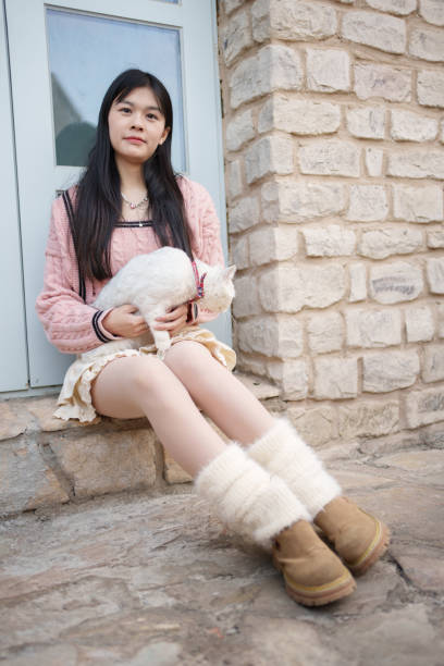 istock Asian woman sitting on the window 1964101768