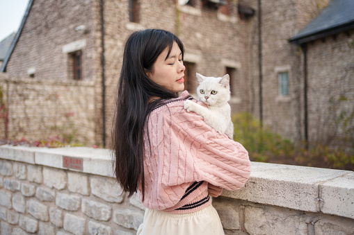Asian woman holding cat