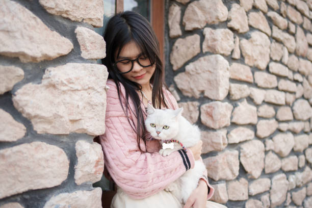 Asian woman holding cat