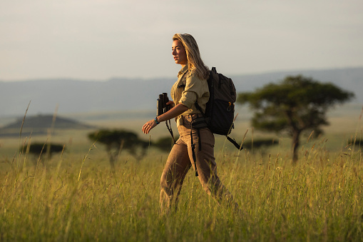 Young woman having walking safari tour in national park