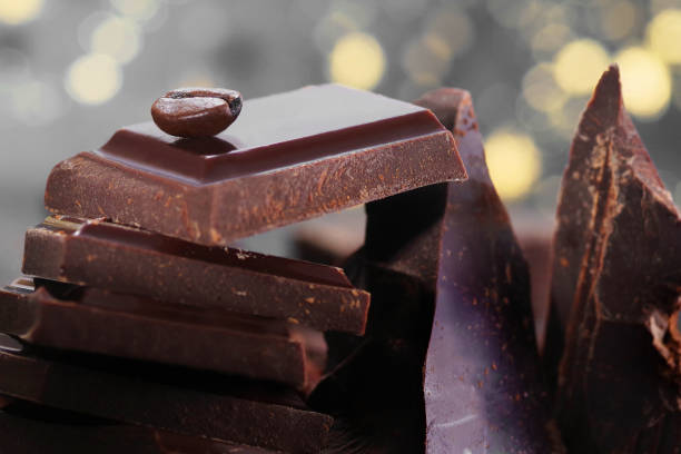 istock Broken dark chocolate and chocolate flakes on a wooden table 1964112017