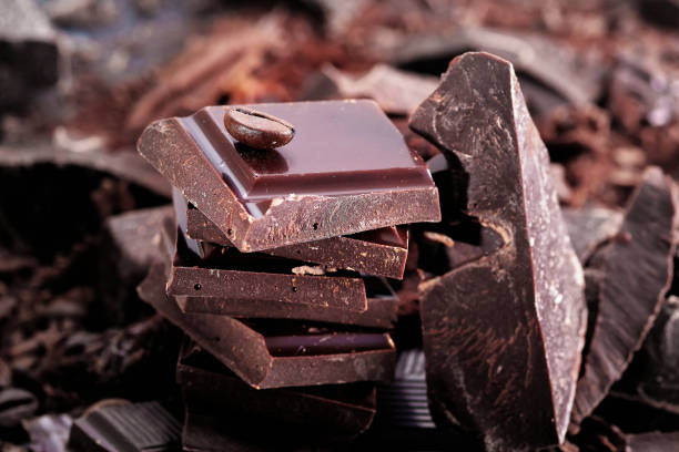 istock Broken dark chocolate and chocolate flakes on a wooden table 1964112520