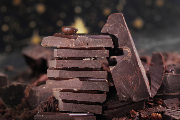 istock Broken dark chocolate and chocolate flakes on a wooden table 1964113043