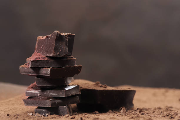 istock Broken dark chocolate and chocolate flakes on a wooden table 1964114599